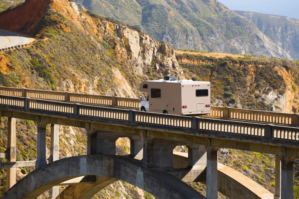 RV crossing bridge over canyon