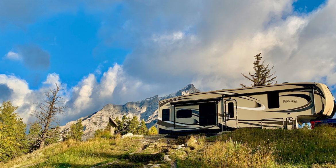 living in an RV with breathtaking Tunnel Mountain, Banff,CA, in the background with clouds.