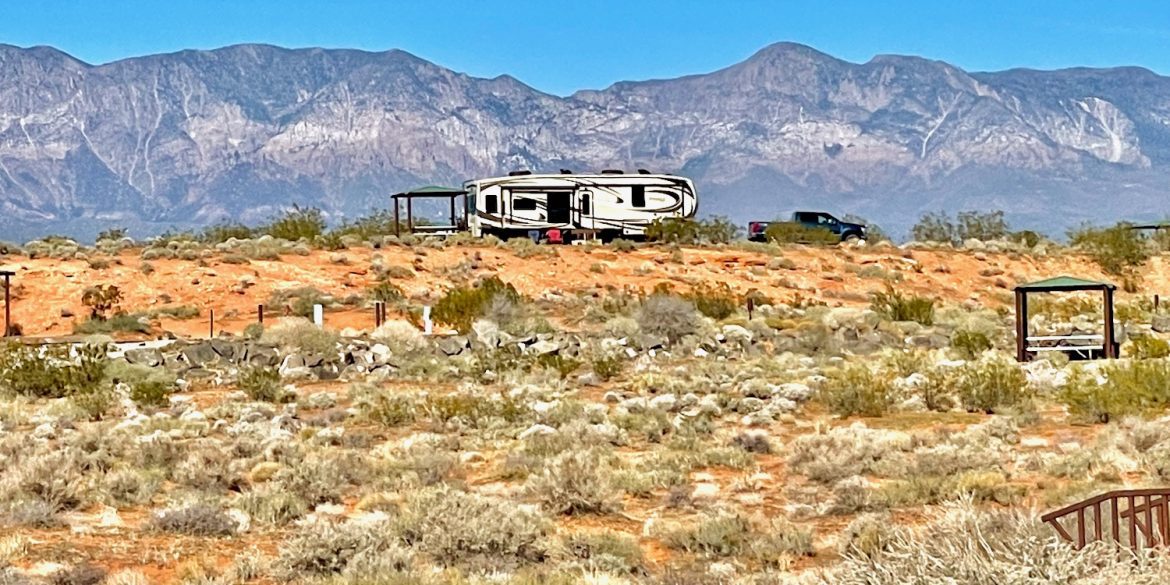 living in an RV (Jayco Pinnacle Fifth Wheel) against a mountain backdrop with desert and tumble week in the forefront
